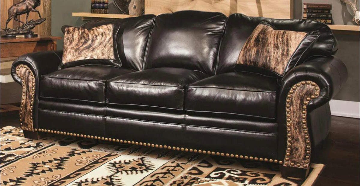 Three Seat Leather Sofa With Rounded Arms And Curved Sofa Back.